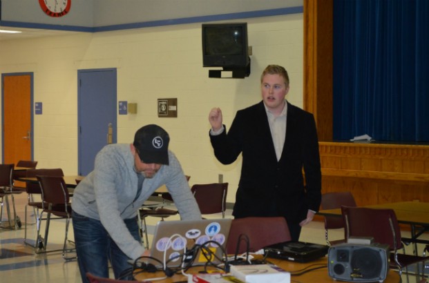 Filmmaker Jeremiah Lofthus asks a question of Scott Drexler, a rancher present at the 2014 Bundy standoff; while Mark Herr, president of The Center for Self Governance, adjusts the volume of the connection bringing Drexler as well as others across the U.S. into the discussion at Tonasket High School Dec. 16