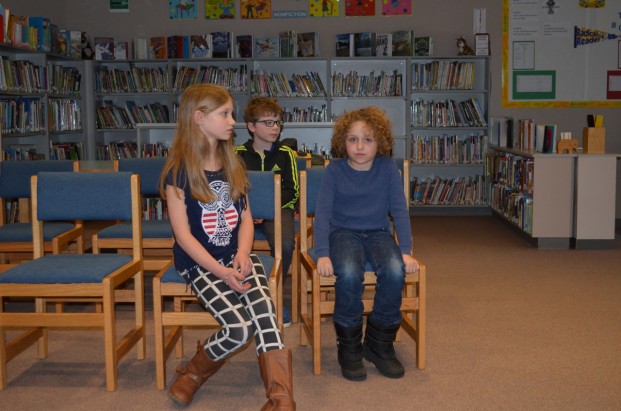 Mackenzie Brock and Xen Fardys prepare for a tie-breaker round in Wednesday's spelling bee at Tonasket Elementary School. Calvin Sutton (back row) took first place by cruising through nine rounds without missing a single word.