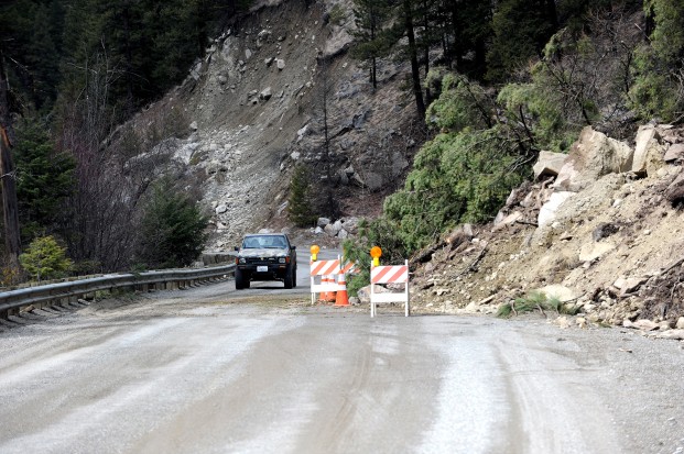 Gary DeVon/staff photo Recent rains led to a rock slide on the Chesaw Road Sunday. Rocks, dirt and debris slid off the sandstone cliffs onto the highway. County crews had one lane cleared and were going to continue work on Monday.
