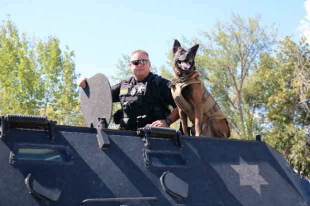 Havoc shows off his protective vest alongside his handler, Sergeant Tait Everett. Tanya Craig/submitted photo