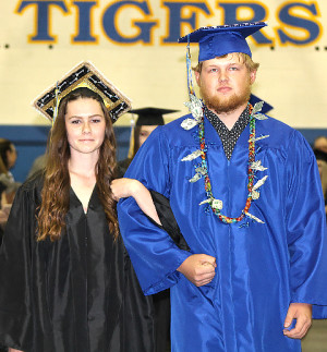 Katie Rawley and Ryker Ayers walk the procession with fellow classmates for the graduation ceremony.