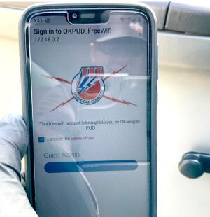 Phone test: Okanogan PUD crew member Lee Taylor connects to the free hotspot his crew recently installed.
