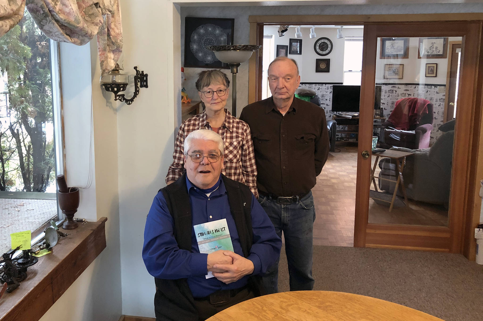 Gary DeVon / staff photo
Arnie Marchand with his new book “What is Your Name?” and his publishers Kay and Mike Sibley at their home in Oroville.