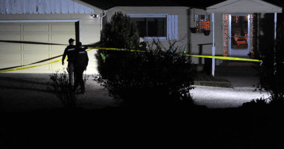 Okanogan County Sheriff’s Deputies secure the residence of murder victim Siri Zosel last Saturday evening. Roy Rasmuseen, 70, Okanogan, was booked for first degree murder in what Sheriff Tony Hawley described as a fatal domestic dispute. <em>Gary DeVon/staff photo</em>