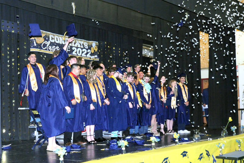 Gary DeVon/staff photos The Oroville High School Class of 2022, diplomas in hand toss their mortarboards in the air as a blast of confetti is fired off.