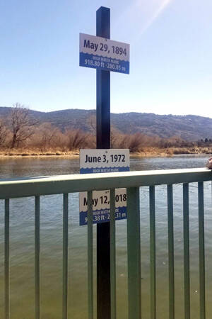 Signs at Oroville's Osoyoos Lake Veterans Memorial Park show floodwater high water marks for 1894, 1972 and 2018.