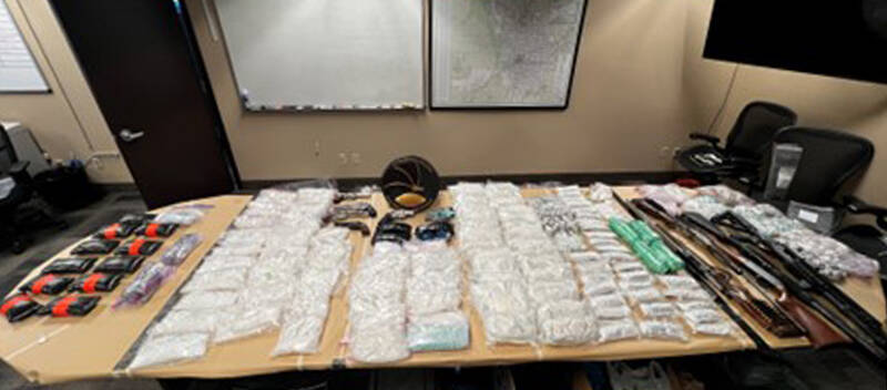 Another view of some of the drugs and weapons seized.