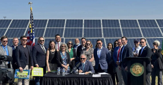 Gov. Jay Inslee, legislators, and clean energy advocates celebrate the signing of seven bills strengthening Washington’s implementation of clean energy policies. Image courtesy of Gov. Inslee’s Medium page