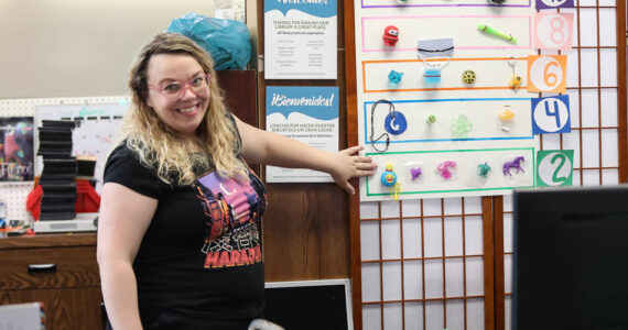 Tonasket librarian Sara Dunn invites readers of all ages to come check out the different summer crafting and reading activities held at the library. She said there is something for everyone and back by popular demand is the “Guessing Jar.” Summer readers can take a guess at how many starbursts are in the jar and win a prize. Laura Knowlton/staff photo