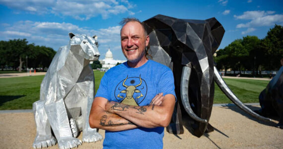 Artist Quill Hyde poses with their exhibit for PETA on the National Mall in Washington, DC. Submitted photos/PETA