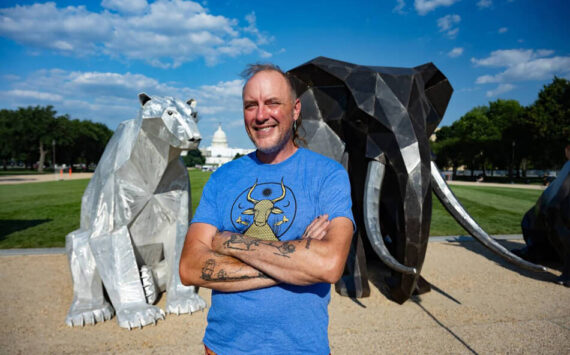Artist Quill Hyde poses with their exhibit for PETA on the National Mall in Washington, DC. Submitted photos/PETA