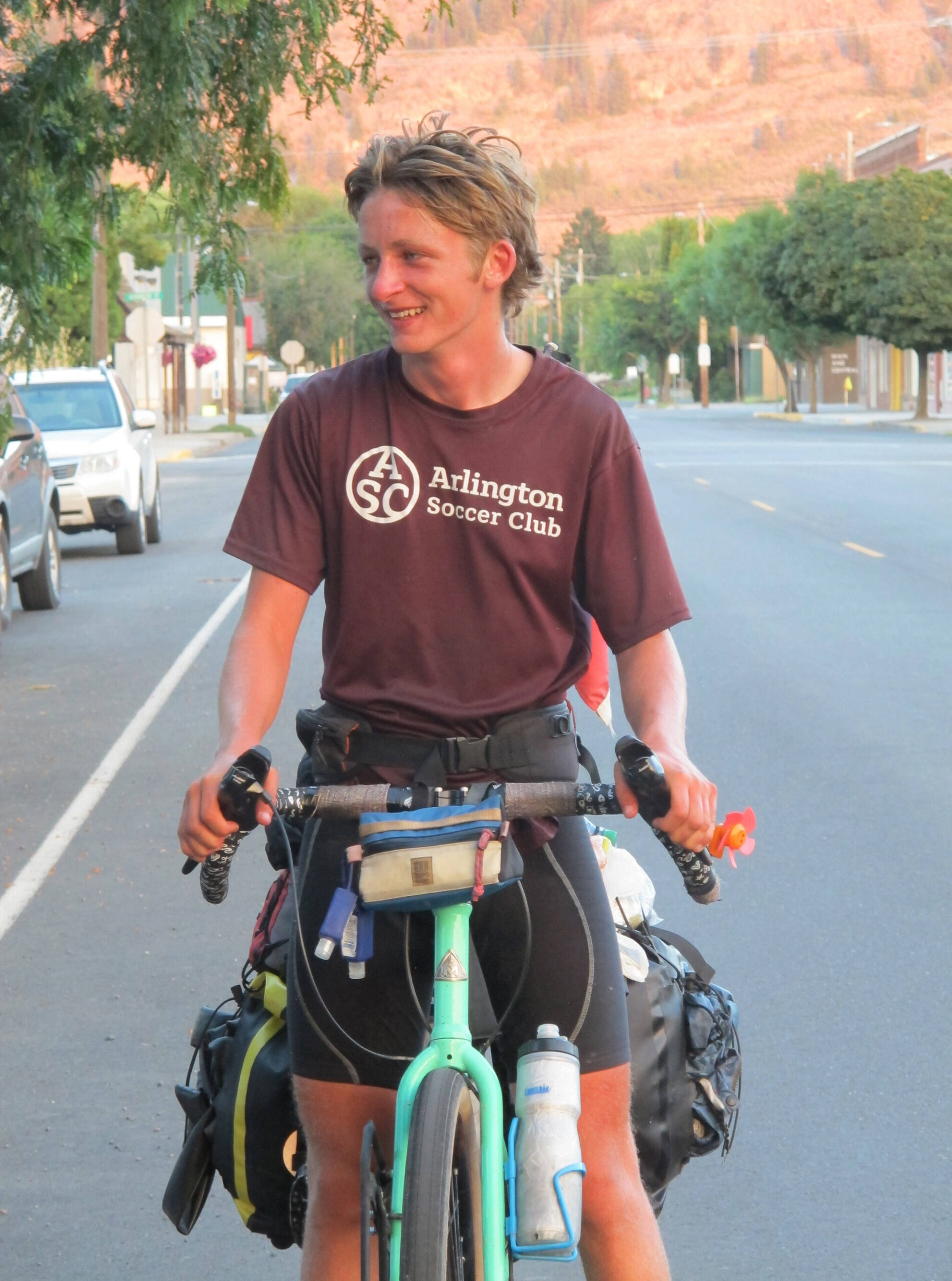 Submitted photo 
Brooks Enzensperger, 16, arrives in Oroville after cycling 3500 miles from Vermont to his grandfather’s in Oroville as a challenge to himself. He was greeted by well wishers including his grandfather Joseph Enzenspeger and his great aunt.