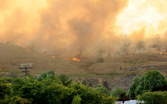 The Eagle Bluff Fire burns along the ridgeline west of Oroville after traveling three miles from Blue Lake Road, as seen from the Oroville Post Office. The fire, which took place in late July, eventually crossed the border into Canada.
<em>Gary DeVon/GT File Photo</em>