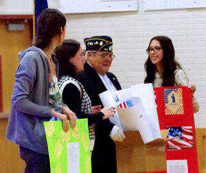American Legion Post Commander Arnie Marchard receives appreciation gifts and cards from students of the OSD.