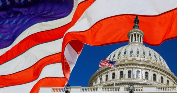 A panoramic view United States Capitol Building at Washington, DC, USA with American flag. Adobe Stock Photo