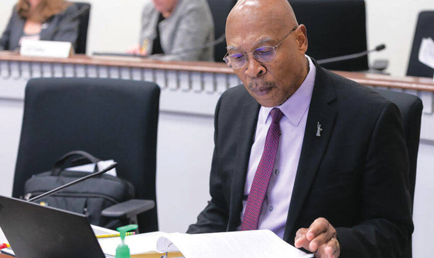 Sen. John Lovick studies a proposal at his desk on the floor of the Senate. Photo courtesy of Senate Democrats