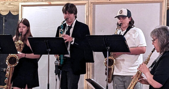 Bryan Zeski/submitted photo
OHS Band Director (right) Valerie Coolidge leads Oroville Band members (left to right) Kwani Harding, Steven Brand and Ezekiel Pruett during the Grange Concert.