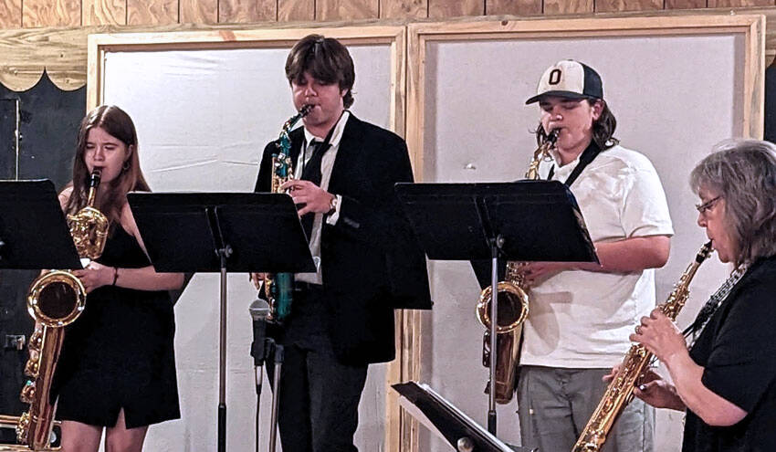 Bryan Zeski/submitted photo
OHS Band Director (right) Valerie Coolidge leads Oroville Band members (left to right) Kwani Harding, Steven Brand and Ezekiel Pruett during the Grange Concert.