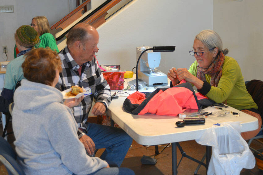 Robert Mueri/staff photos
Susan Spurlin uses her sewing skills to mend a coat at Green Okanogan's Repair Café held last Saturday at the Community Cultural Center at Tonasket.