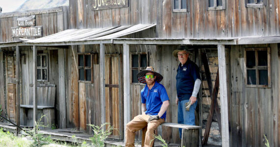 Anthony Katsonis and Robert Schardein of Silverline Lakeside Resort, Winthrop, work to carefully dismantle the old town facade to relocate to its new home. Laura Knowlton/staff photo