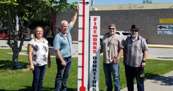 Shelly Roberts, Rocky DeVon, Mayor Ed Naillon and Paul Bouchard with the Oroville Washington Chamber of Chamber pose with the community fundraising meter which shows that $7000 has been raised so far for the Fourth of July Community Fireworks Display at Deep Bay Park. The meter was constructed by Paul Bouchard Woodworking. <em>Submitted photo </em>