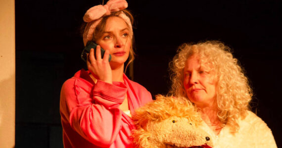 Danika Smith in the lead role as Diedra in “The Pack,” a new theater production showing at the Tonasket Community Cultural Center. She is seen here with Julie Alley, who plays the new poodle puppy Maxi. Rob Thompson/submitted photos