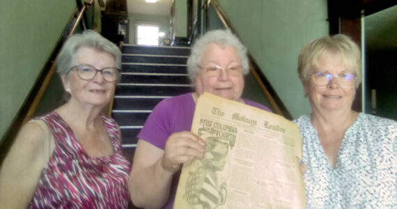 Donna St. John, who helped deliver the old <em>Molson Leader</em> and <em>Oroville Gazette</em> issues to the Molson Schoolhouse Museum with museum volunteer Joanie Emry Raymond and Janet Barstow, manager of the Roy M. Chatters Newspaper and Printing Museum. Salley Bull/submitted photos