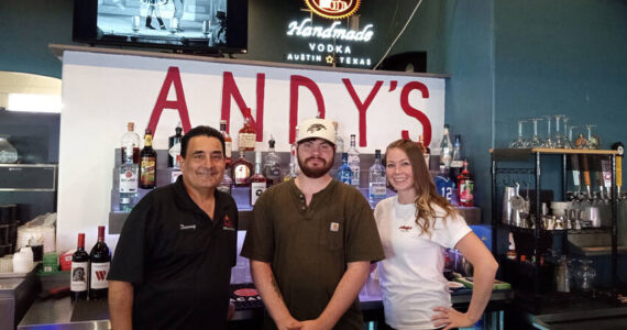 Easton Anderson with some of the staff of Andy’s Bar & Grill. Angela Larson/staffphoto