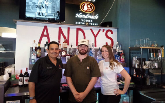 Easton Anderson with some of the staff of Andy’s Bar & Grill. Angela Larson/staffphoto