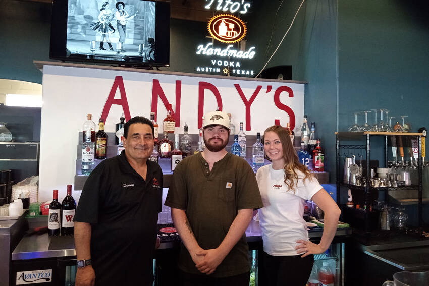 Easton Anderson with some of the staff of Andy’s Bar & Grill. Angela Larson/staffphoto