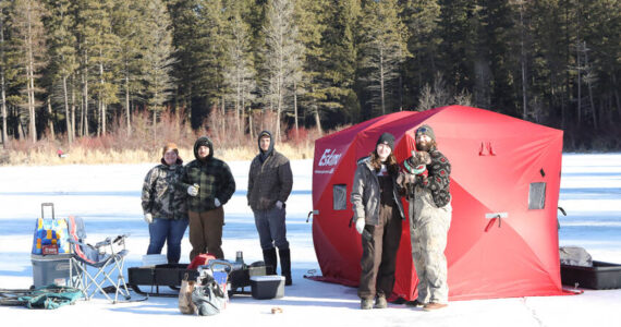 Anglers line the ice at Bonaparte Lake during the 4th Annual Ice Fishing Derby held last Saturday, drawing famillies and competitors out for a day of winter fun. Laura Knowlton/staff photo
