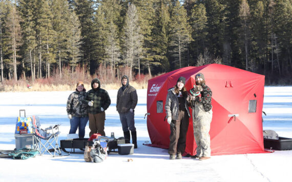 Anglers line the ice at Bonaparte Lake during the 4th Annual Ice Fishing Derby held last Saturday, drawing famillies and competitors out for a day of winter fun. Laura Knowlton/staff photo