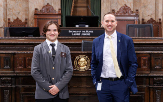 Page Teak Plank with Rep. Hunter Abell at the Speakers Rostrum on the House floor, Jan. 29. Washington State House of Representatives photo