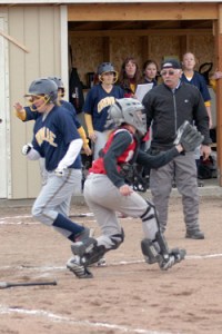 Photo by Gary A. DeVon                Oroville’s Reinna Quick is brought home on an Emily Graham triple last week against the Waterville Shockers. The Hornets easily won each o