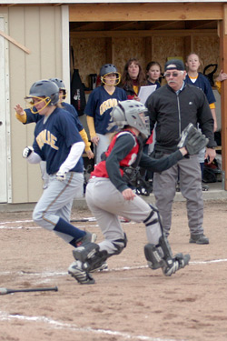 Photo by Gary A. DeVon                Oroville’s Reinna Quick is brought home on an Emily Graham triple last week against the Waterville Shockers. The Hornets easily won each o