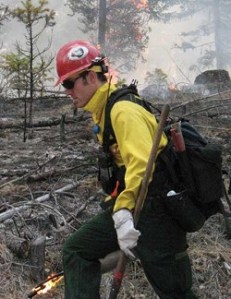 Photos by Amy VenezianoA firefighter continues to set fire while a ponderosa pine burns up in a crown fire behind him. Crown fires can send flames as much as 300 feet into the air.