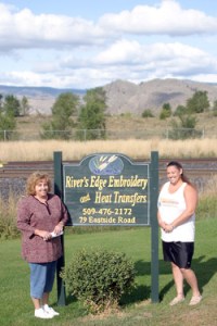 Photo by Gary DeVon Jennifer Finsen (left) and her sister Carrie Buckmiller near the sign for the new Riverâ€™s Edge Embroidery store. Finsen, who used to work at Ethyls on Main Street in Oroville, is opening the busi