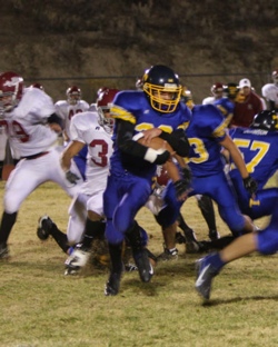 Photo by Terry MillsSenior Justin Mann protects the football as he works his way through Okanogan and Tonasket players during Tonasket’s home game against Okanogan on Friday, Oct. 24.