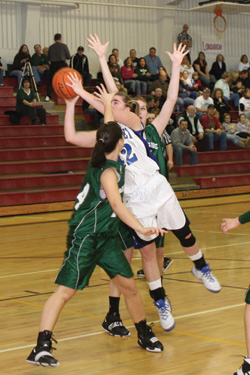 Tonasket senior Cierra Silverthorn leaps over two LakesideHigh School players during the Lady Tiger’s