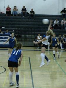 Tonasket junior Brooke Ray jumps up to hit the ball over the net during Tonasket’s home game against Omak on Tuesday, Sept. 29. Also shown are junior Jessica Rhoads (#11), sophomore Amber Kilpatrick (#3) and sophomore Taylor Ayers (#2).Photo by Emily Ha