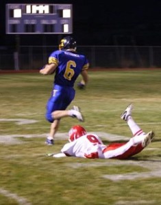 Tonasket junior running back Keegan McCormick runs toward the end zone for the first touchdown of the night, scored 23 seconds into the game, as the last Brewster defender with a chance of stopping him, freshman defensive back Danny Ramirez, falls to the