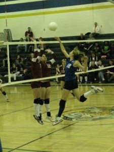 Tonasket freshman Devan Utt jumps up in the air to knock the ball back to Okanogan during Tonasket’s final home game of the season. Tonasket lost in three sets of 25-13, 26-24 and 25-16. Photo by Emily Hanson