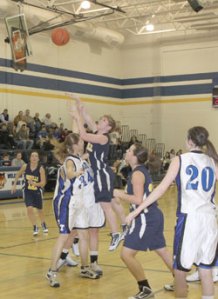 Oroville senior Kayla McKinney making a shot over Tonasket junior Jerian Ashley during Oroville’s away game at THS on Tuesday, Dec. 8. Also shown is Tonasket junior Shelby Olma (20). Photo by Terry Mills