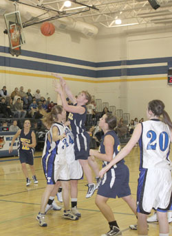 Oroville senior Kayla McKinney making a shot over Tonasket junior Jerian Ashley during Oroville’s away game at THS on Tuesday, Dec. 8. Also shown is Tonasket junior Shelby Olma (20). Photo by Terry Mills