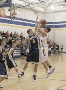 Tonasket junior Zach Neal shoots the ball over Oroville senior Brandon Funston during Tonasket’s home victory over Oroville on Tuesday, Dec. 8. Photo by Terry Mills