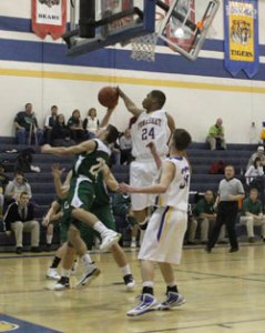 Tonasket senior Terrell Cross jumps up to stop Chelan freshman Michael Amsel, Jr. (20) from scoring during Tonasket’s home loss to Chelan on Tuesday, Dec. 15. Also shown is junior Corbin Moser (32). Photo by Terry Mills