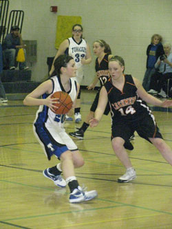 Tonasket junior Shelby Olma looks for a teammate to pass to past Cashmere senior Shelby Holt during Tonasket’s home game against Cashmere on Saturday, Jan. 9. Photo by Emily Hanson