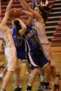 Shelby Olma, a junior for the Tonasket girls’ basketball team tries to make a shot against Cascade despite having the Kodiaks blocking it from either side during Tonasket’s loss to Cascade on Saturday, Jan. 16. Photo by Ian Dunn