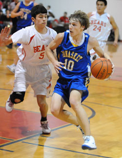 Tonasket sophomore John Stedtfeld moves the ball down the court to the hoop while keeping it away from a Brewster defender during Tonasket’s away game against the Bears on Friday, Jan. 22. Photo by John F. Cleveland, II