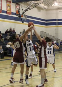 Tonasket junior Michelle Carlson tries to make a shot despite some Okanogan Bulldog’s best efforts to tip it during Tonasket’s home game on Tuesday, Feb. 2. Photo by Terry Mills